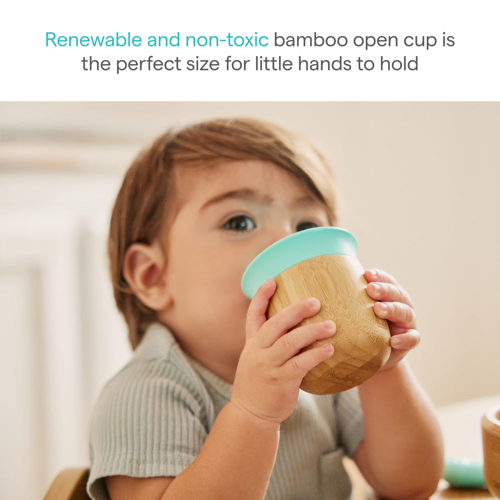 Munchkin Bambou open cup held by toddler demonstrates grip-friendly design.