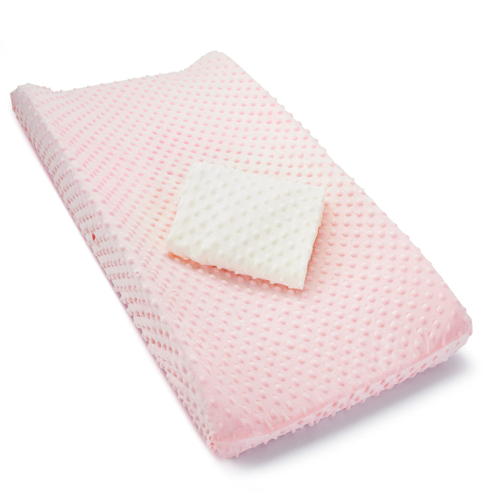 Munchkin changing pad cover in pink and white with textured design for comfy diaper changes.