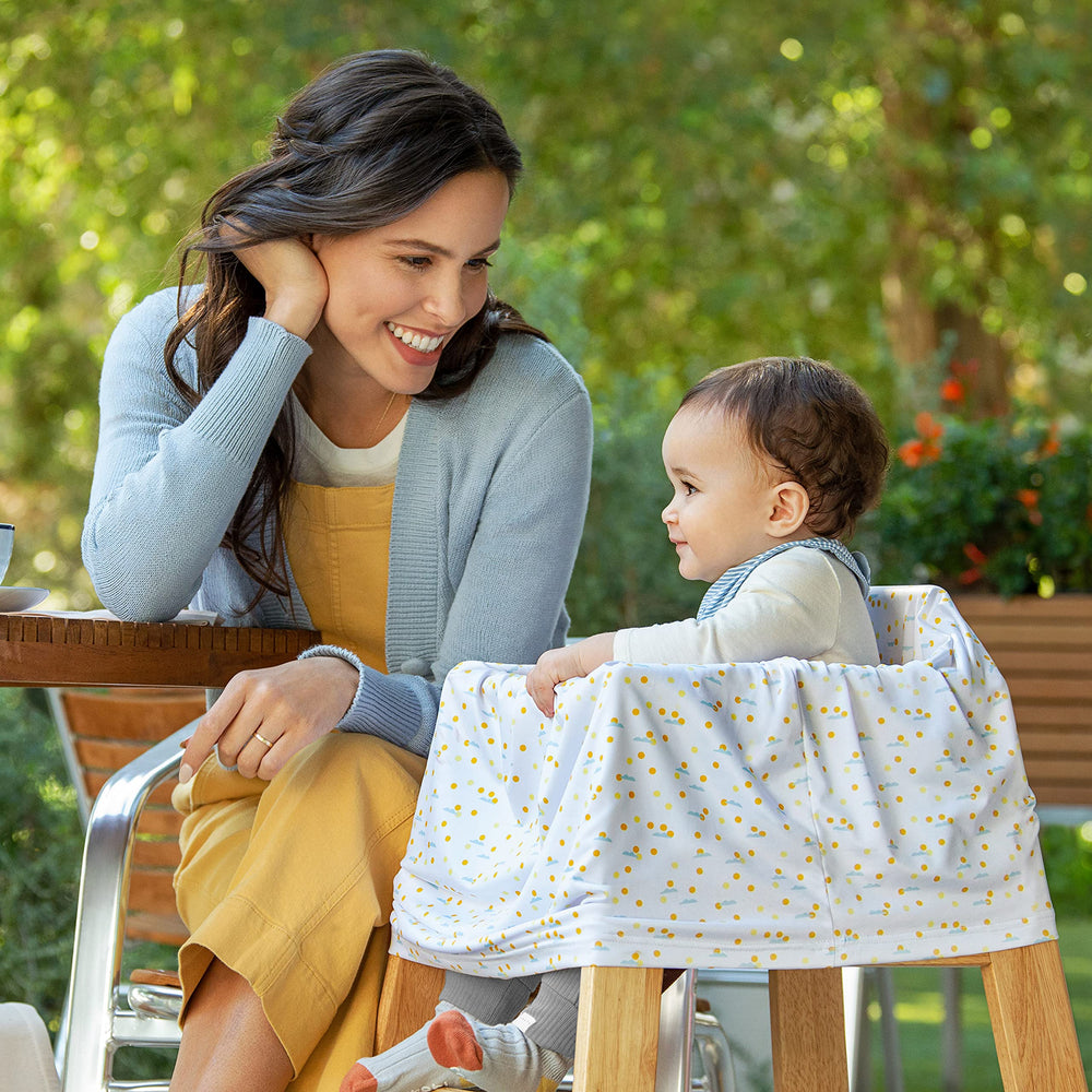 Munchkin Milkmakers high chair cover protecting surfaces at mealtime