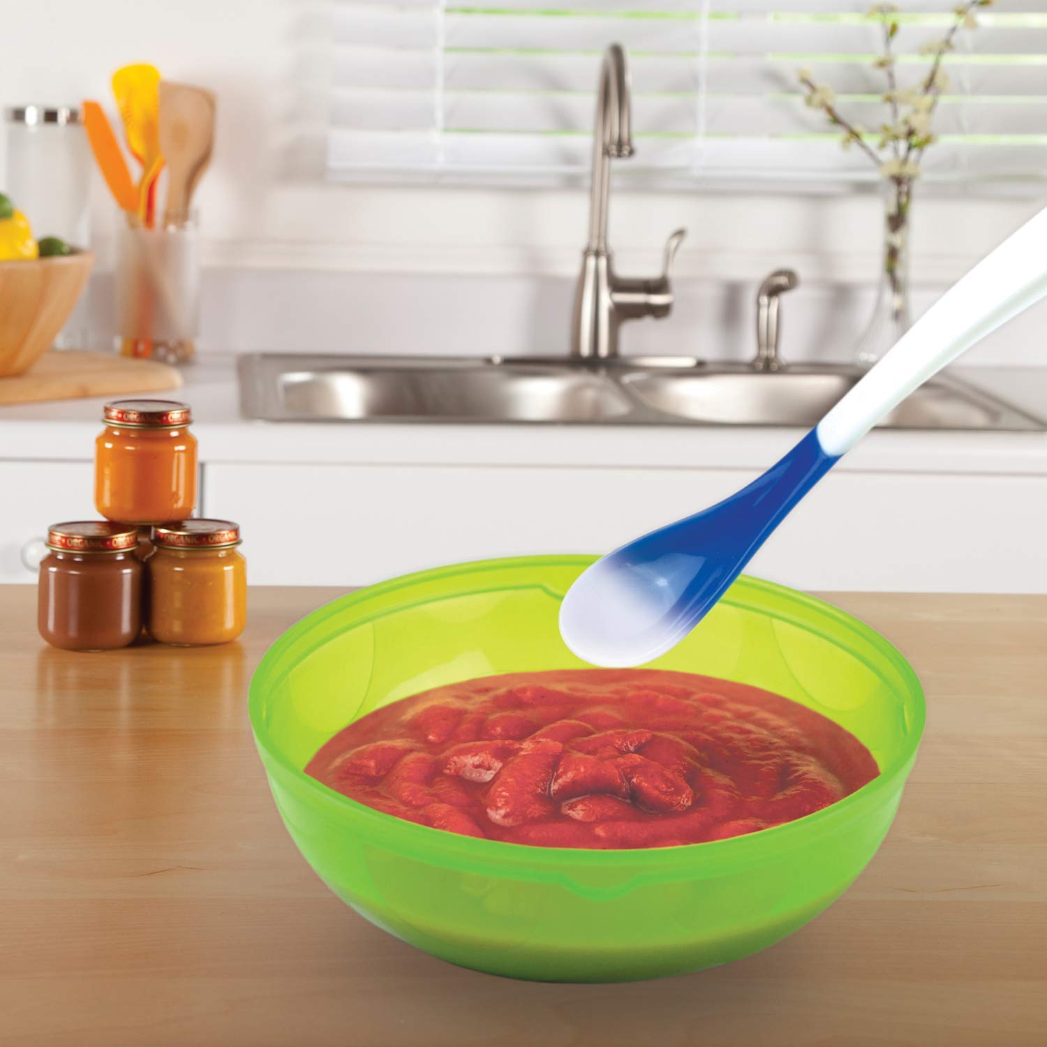 Munchkin White Hot spoon with tapered bowl offers gentle comfort for tiny mouths.