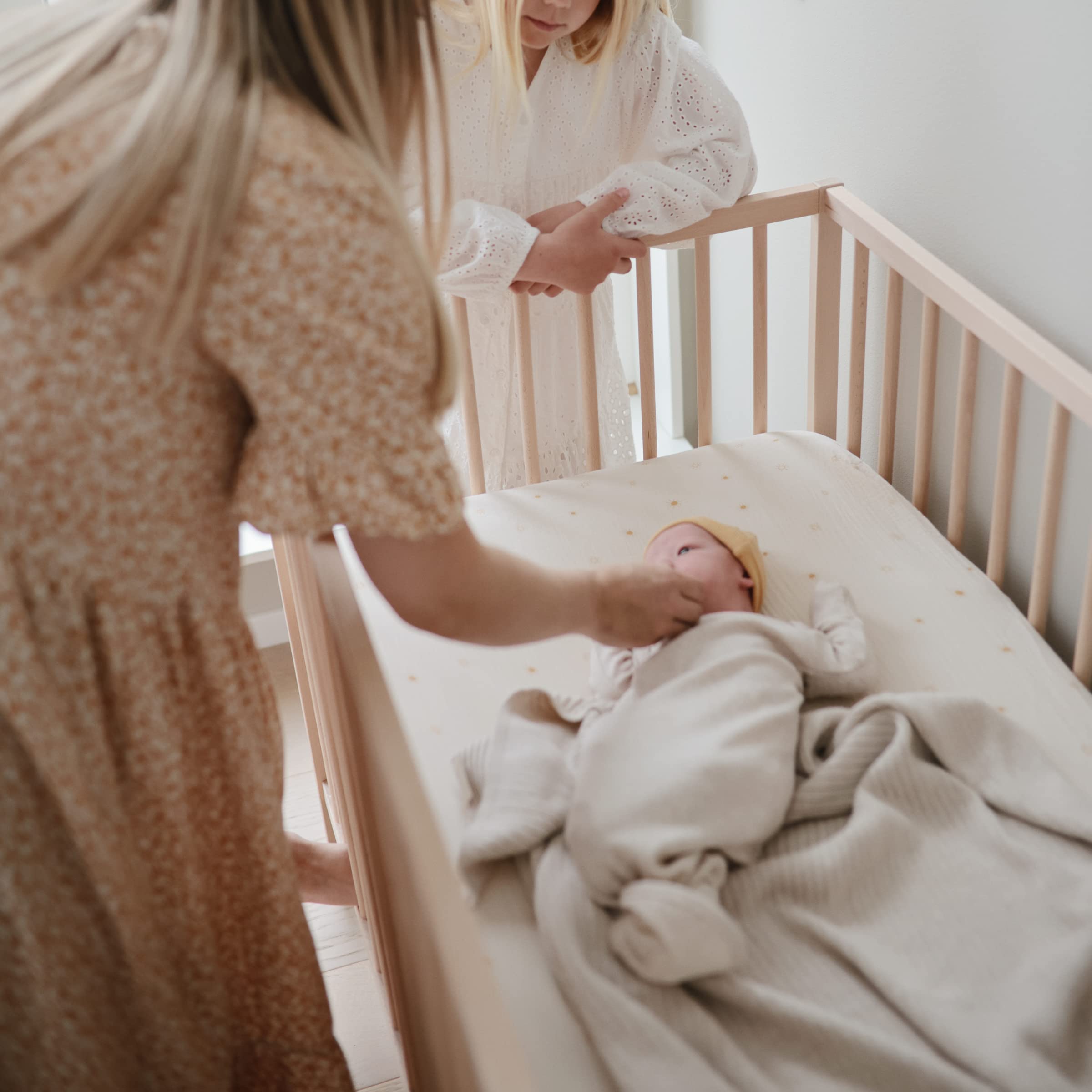 Mushie 100-percent cotton muslin sheet highlights plush softness and gentle touch for newborn skin.