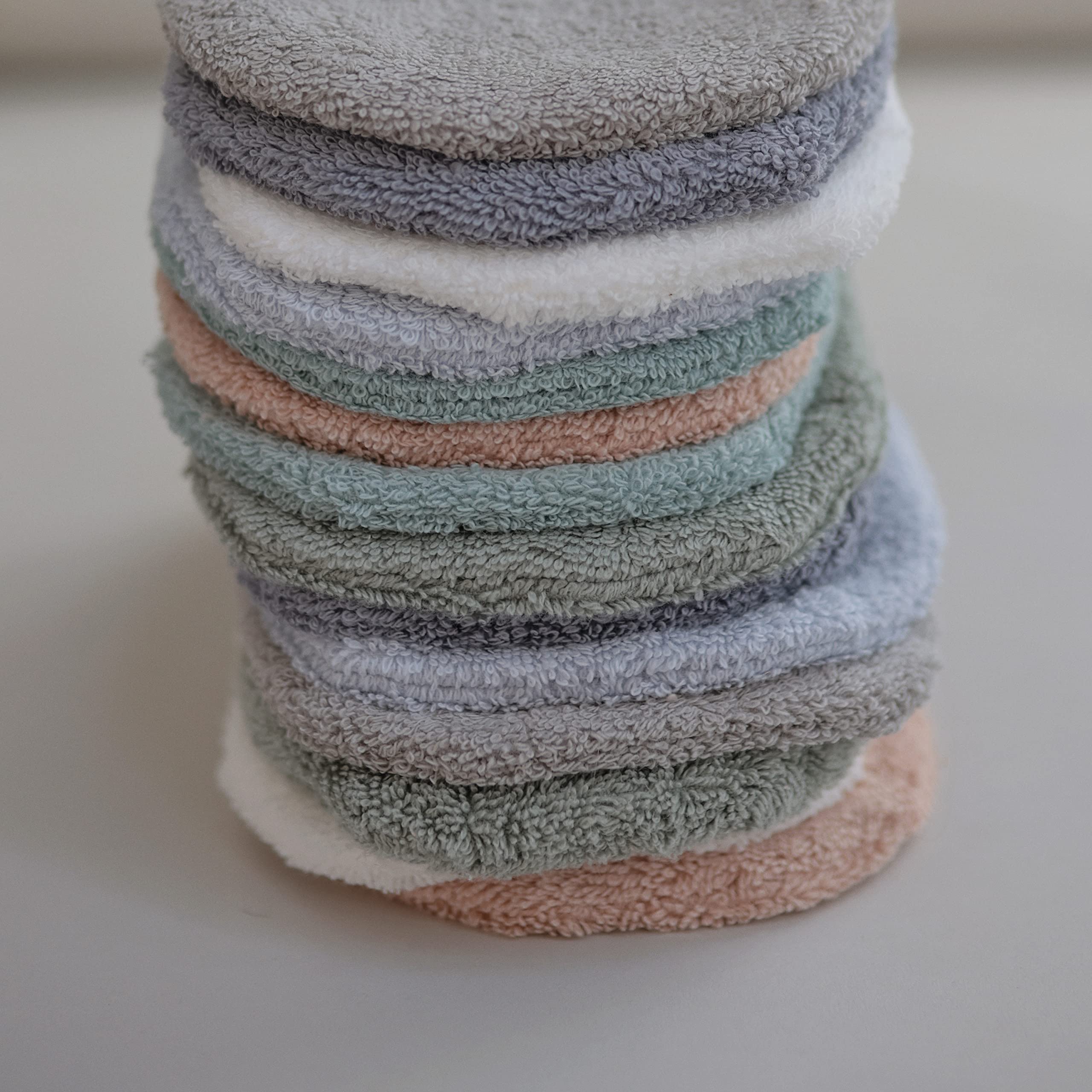 Mushie gray mitt in use during tub time shows absorbent lather aid.