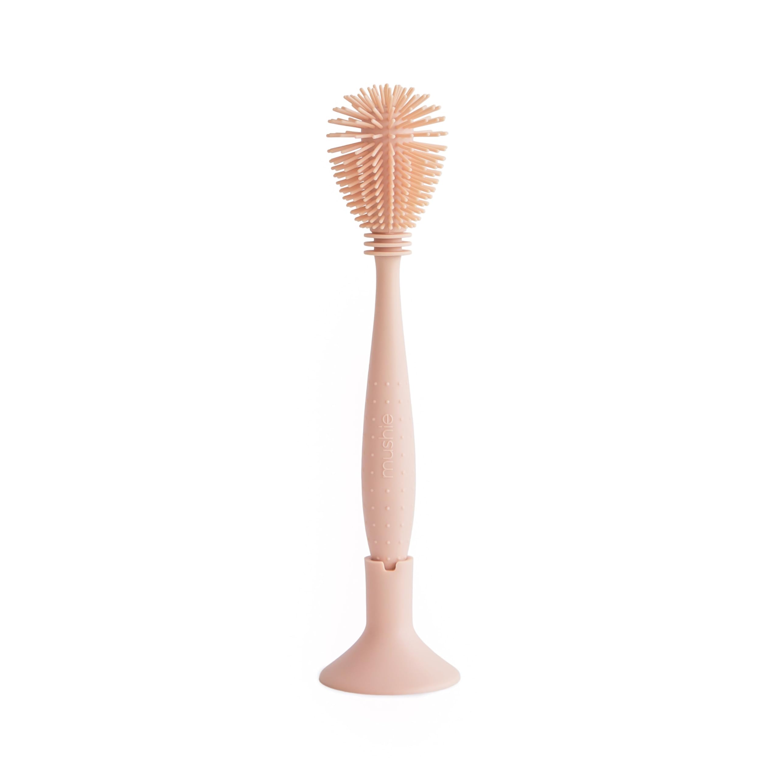 Mushie baby bottle brush with soft silicone bristles for gentle bottle cleaning.