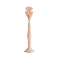 Mushie baby bottle brush with soft silicone bristles for gentle bottle cleaning.