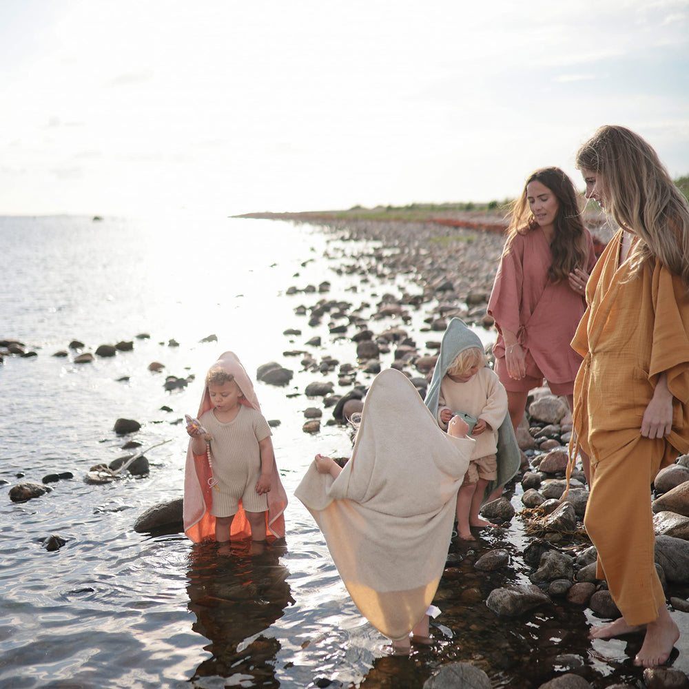 Mushie baby hooded towel pearl soft interior shown for quick, cozy post-bath drying.
