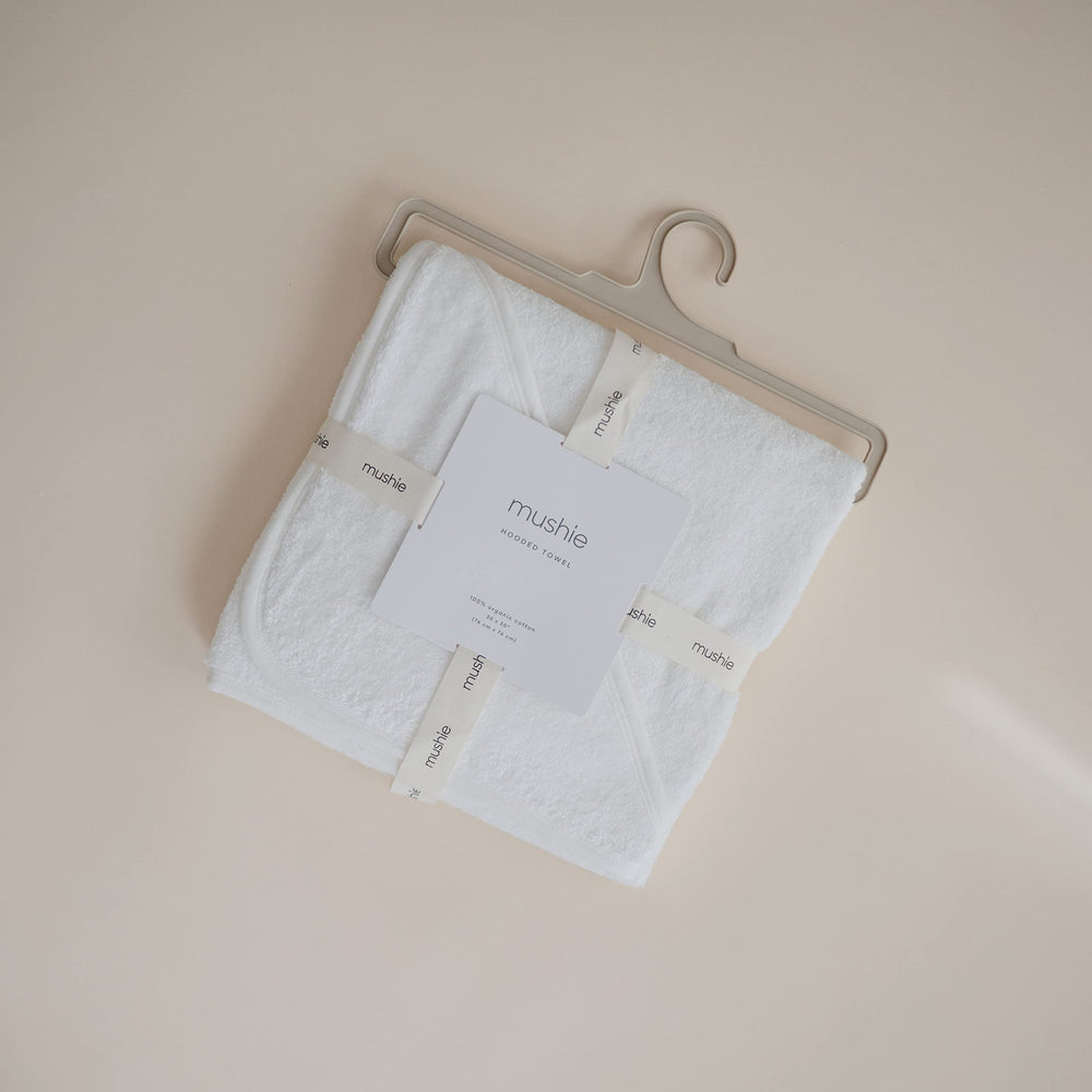 Mushie hooded towel pearl full-body view demonstrates one-size convenience for growing babies.