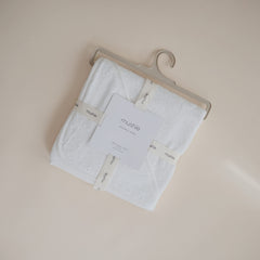 Mushie hooded towel pearl full-body view demonstrates one-size convenience for growing babies.
