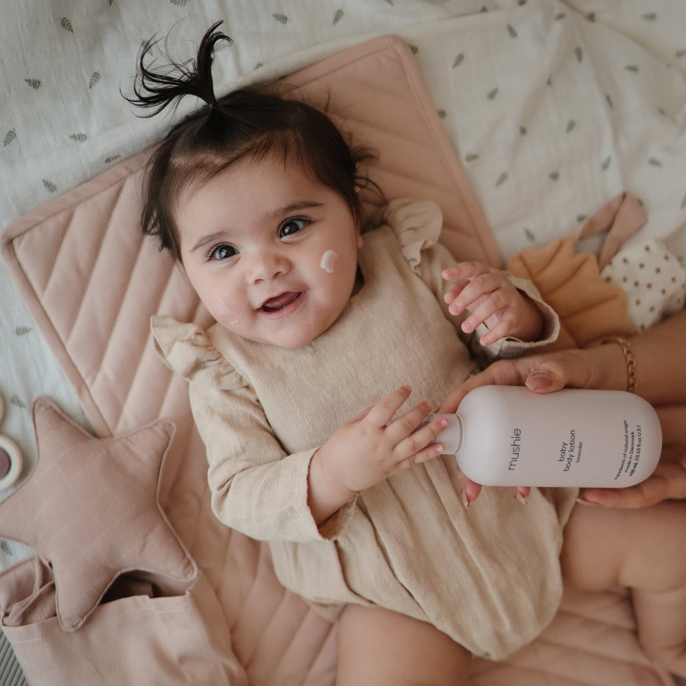 Mushie Baby Organic Body Lotion being applied to dry skin demonstrates daily-use practicality.