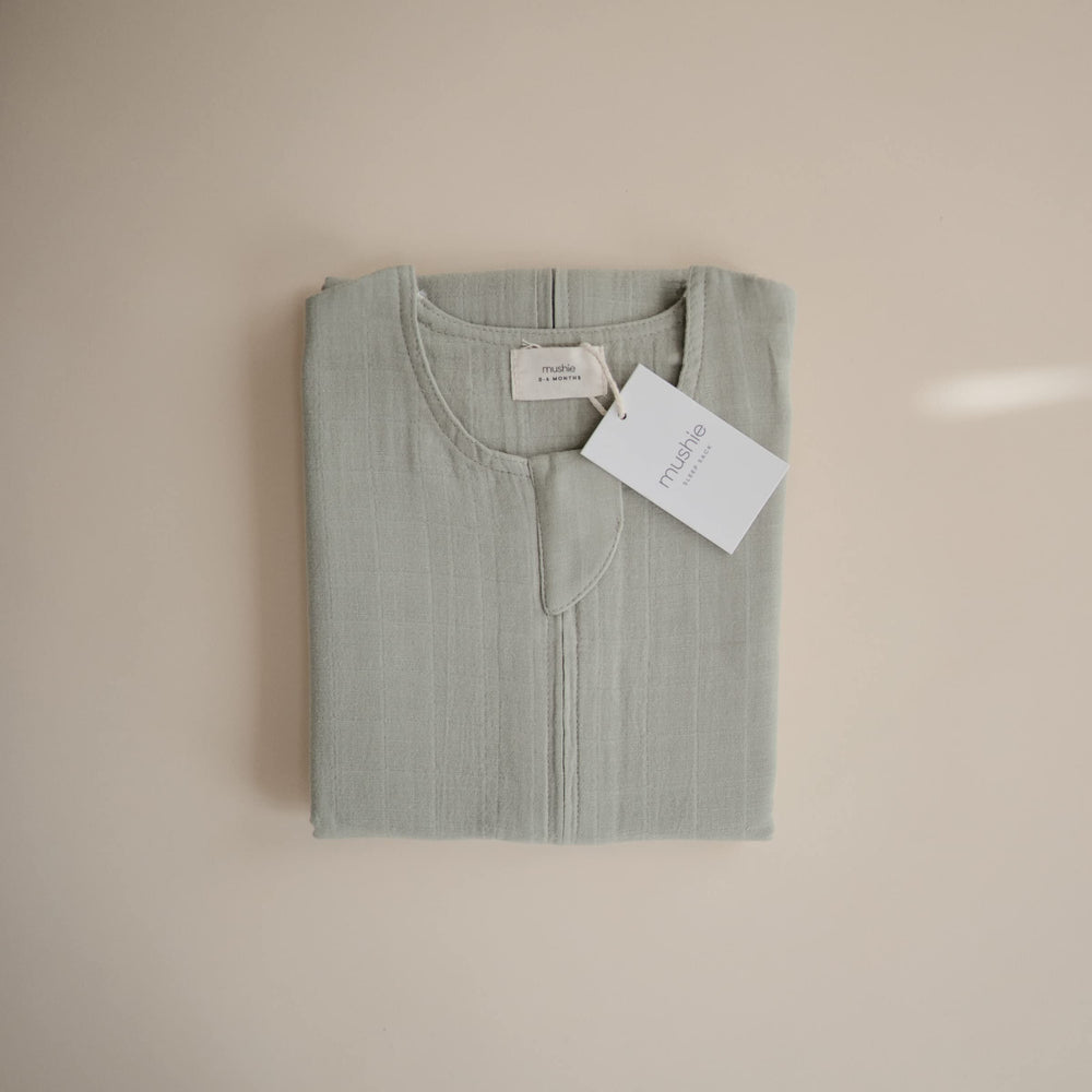 Mushie care instructions for Sage wearable blanket focusing on easy care.