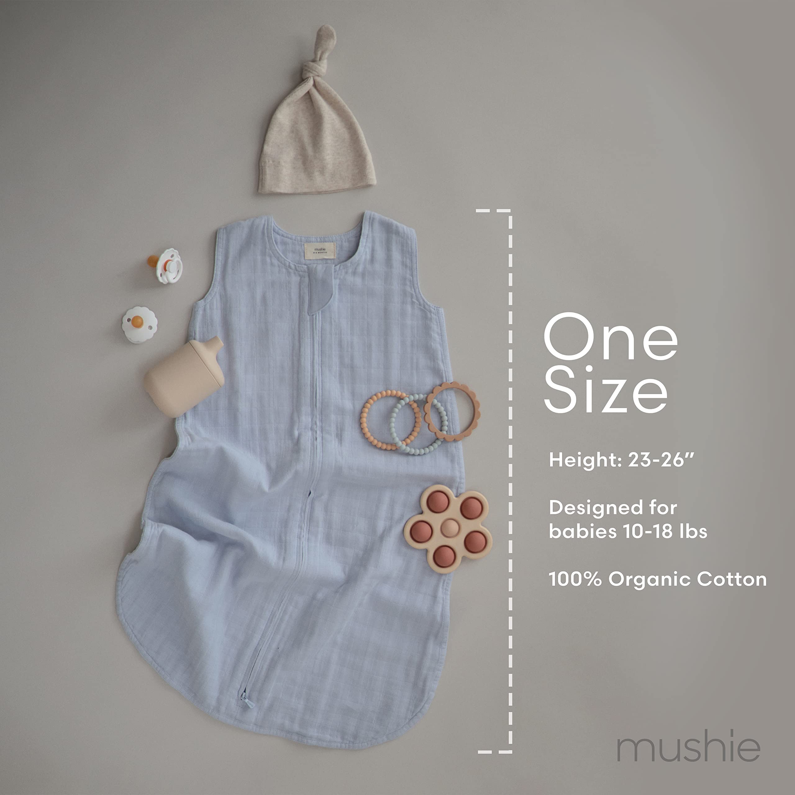 Mushie baby wearable blanket Sage in crib illustrates safe sleep environment.