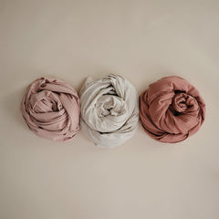 Mushie baby wrap cedar elasticity focus demonstrates stretch for secure, comfortable baby wearing