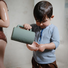 Mushie bath rinse cup in dried thyme color adds calming bath aesthetics.