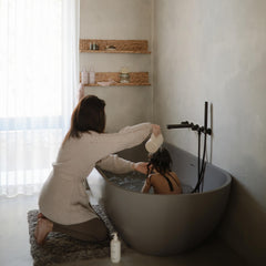 Mushie bath rinse cup ergonomic handle helps parents guide water