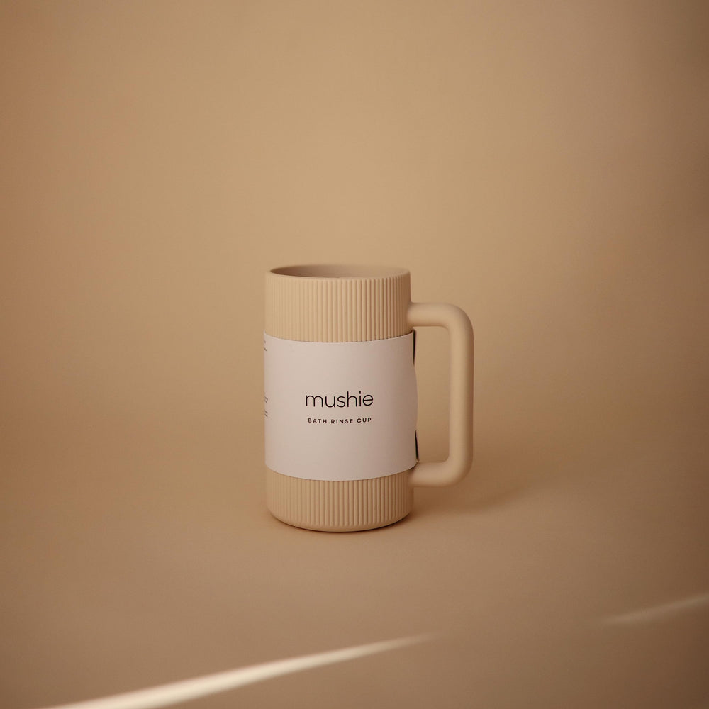 Mushie bath rinse cup textured silicone provides secure grip while pouring