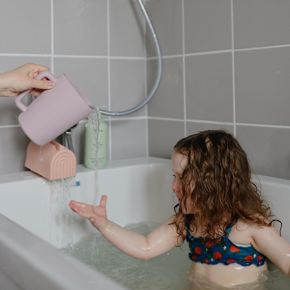 Mushie Bath Spout Cover Rose soft material closeup emphasizes cushiony protection