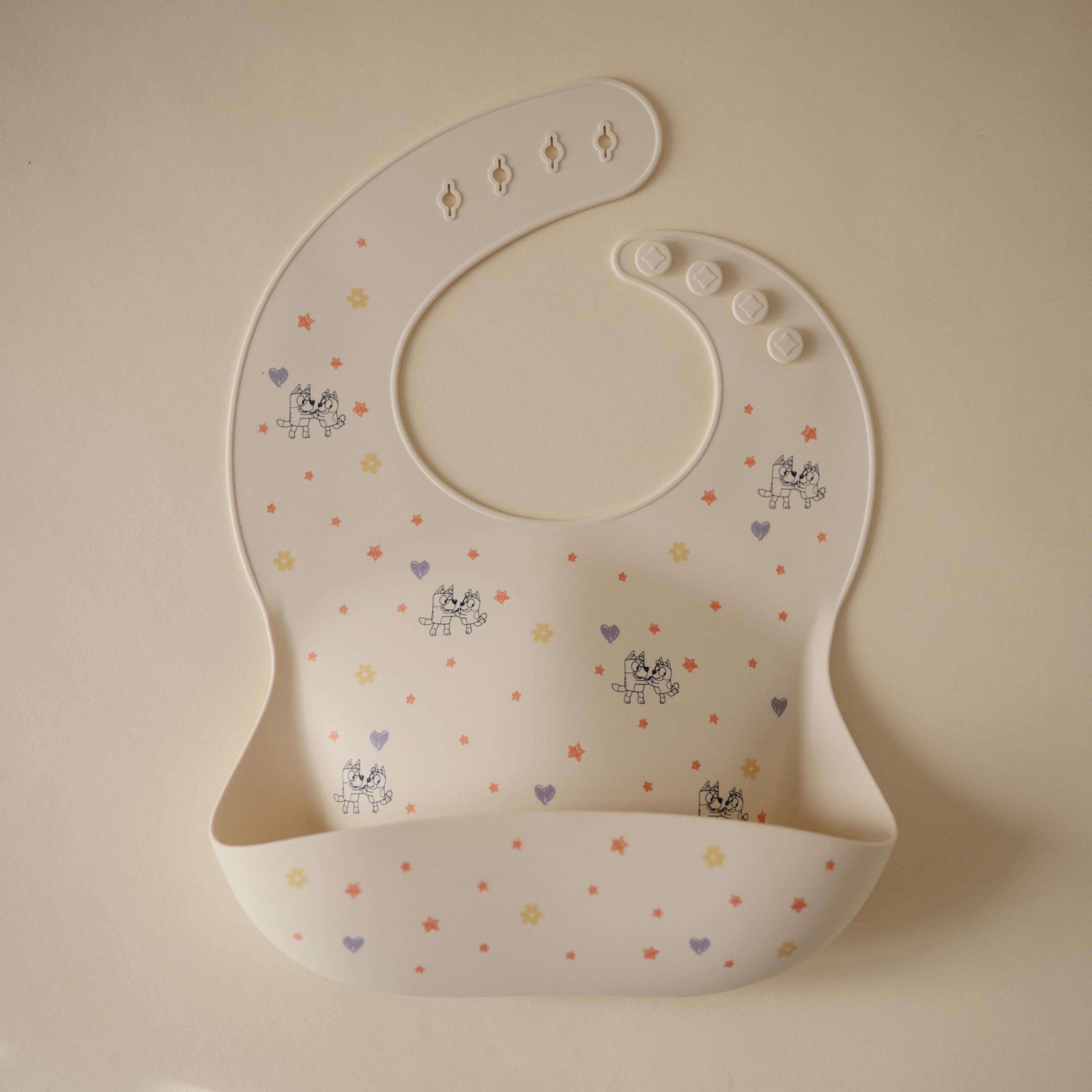 Mushie Bluey bib silicone material texture closeup shows easy-to-clean, BPA-free comfort.