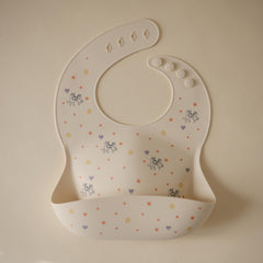 Mushie Bluey bib silicone material texture closeup shows easy-to-clean, BPA-free comfort.