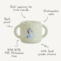 Mushie Bluey silicone snack cup for baby feeding and self-feeding practice.