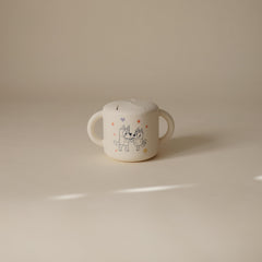 Mushie Bluey silicone snack cup spill-proof design for mess-free on-the-go snacking.