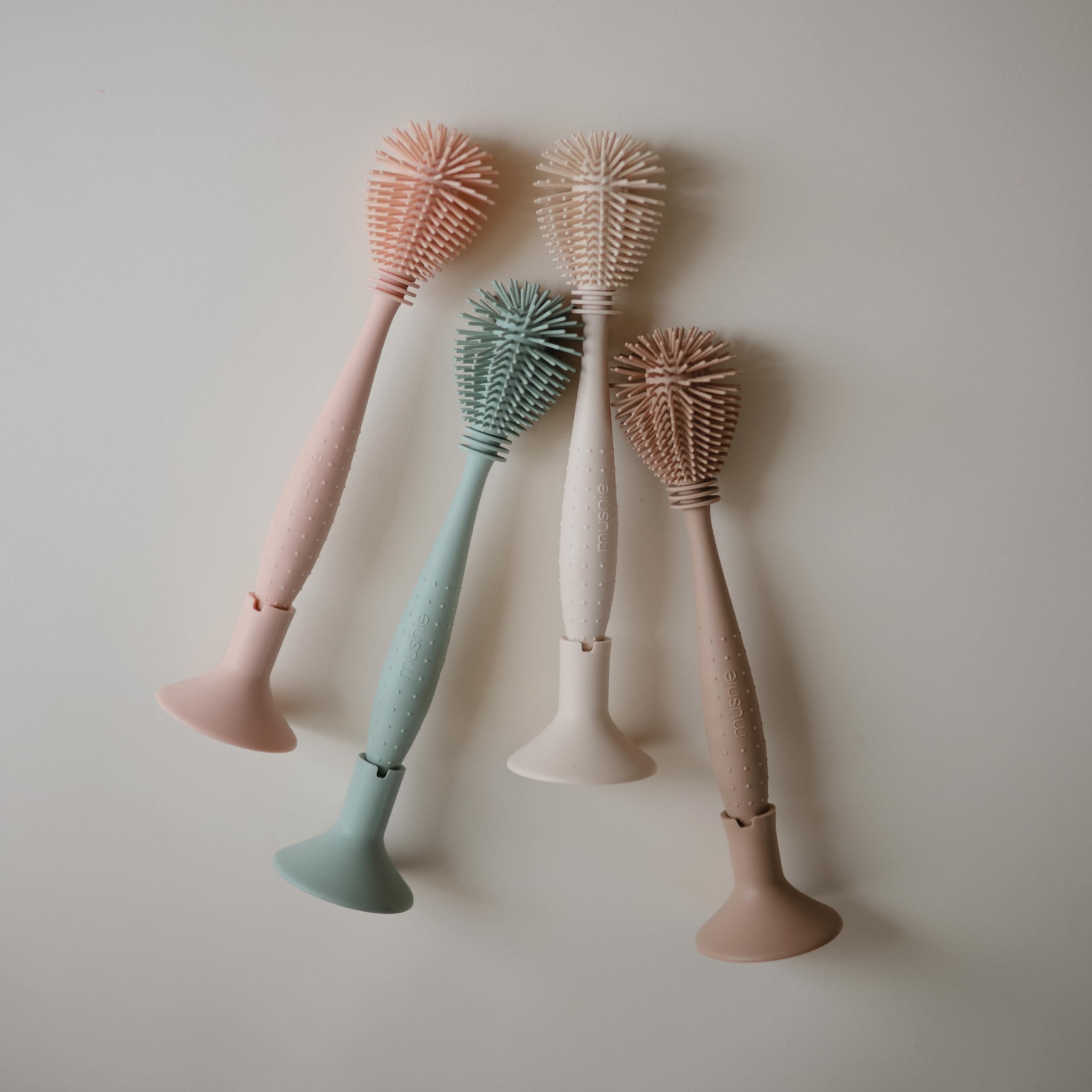 Mushie bottle brush ergonomic handle for comfortable scrubbing.