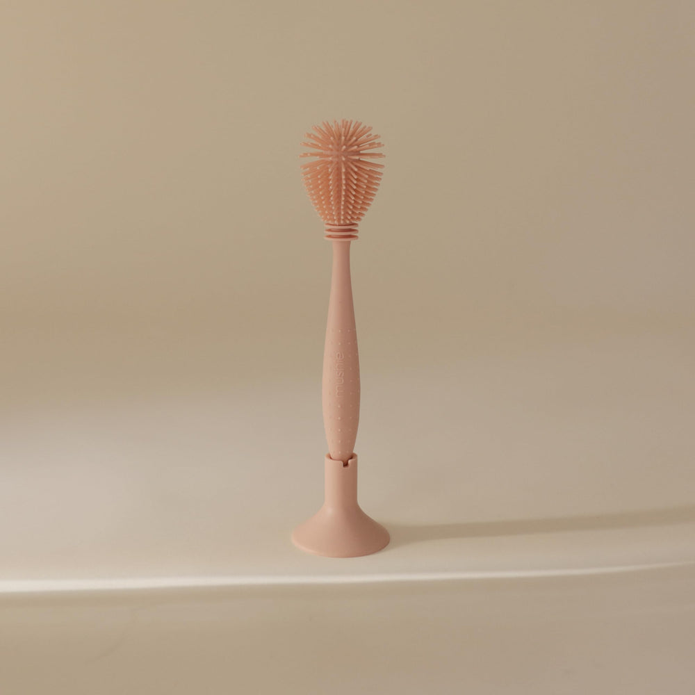 Mushie suction-base design keeps the brush ready for quick storage.