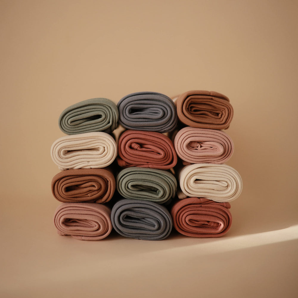 Mushie brand-story visual conveying calm Parenthood mission and safe, functional baby essentials.