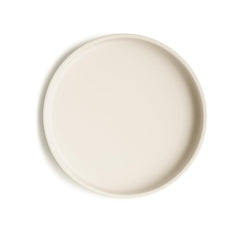 Mushie classic silicone suction plate ivory on table shows secure grip for mess-free meals.