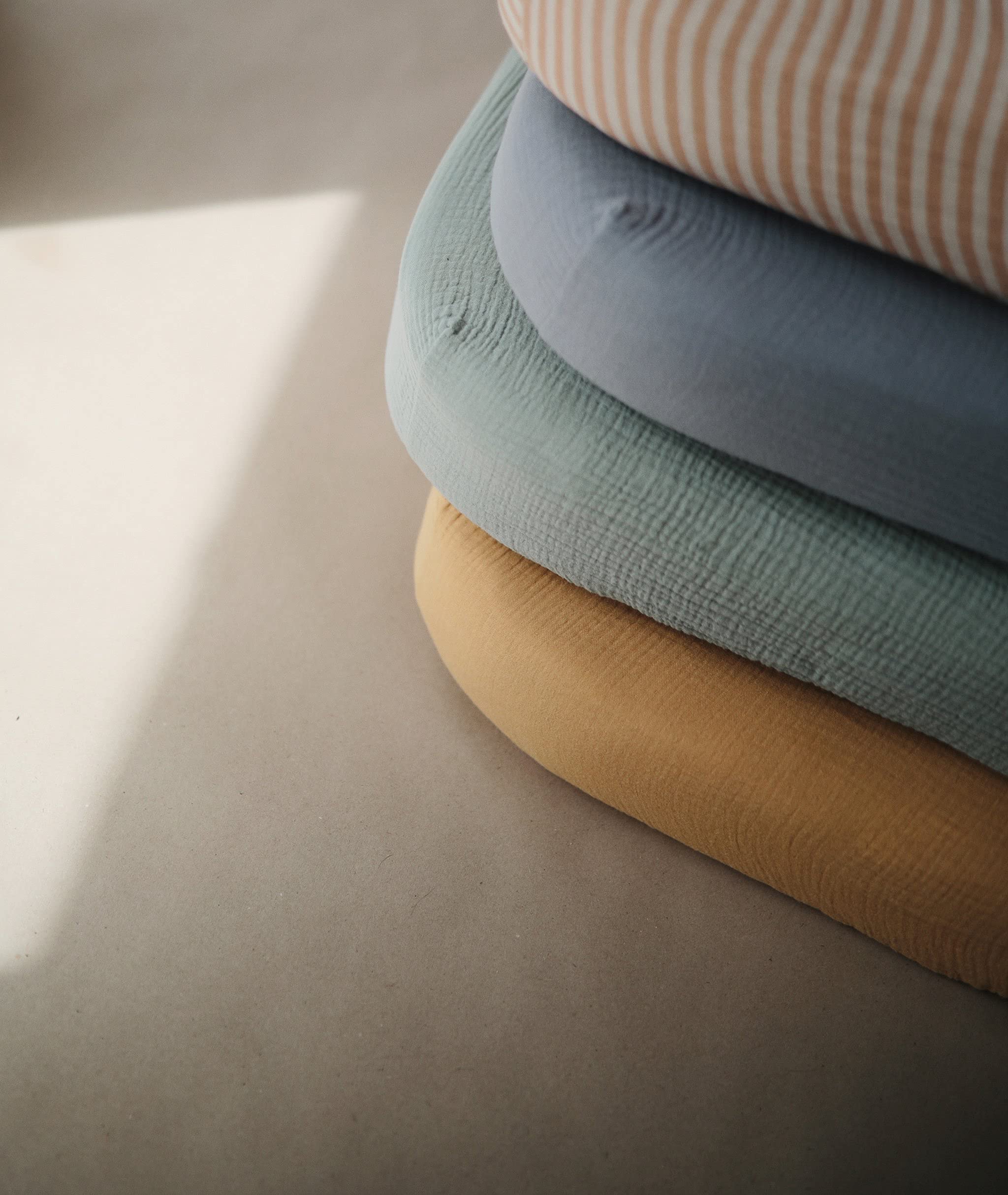 Mushie 52x28x5 inch standard mattress fit keeps sheet in place.