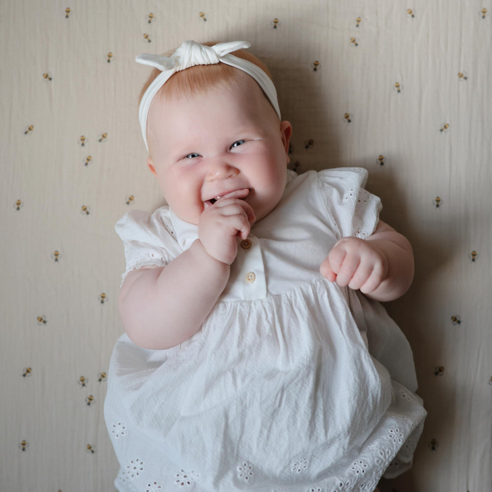 Mushie deep-pocket fit keeps standard 28x52 crib mattress snug.
