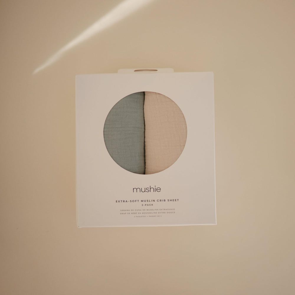 Mushie elastic fitted sheet for simple removal and secure mattress hold.