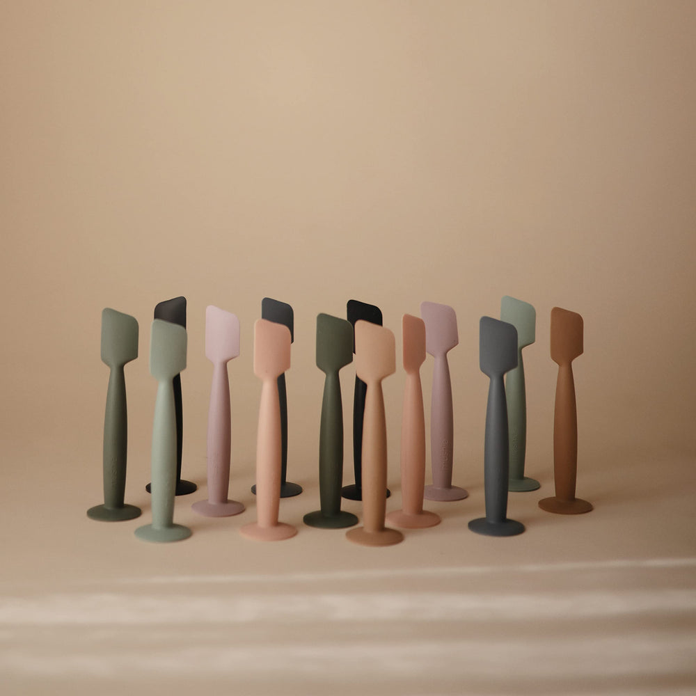 Mushie Diaper Cream Applicator demonstrates a smooth sweeping motion