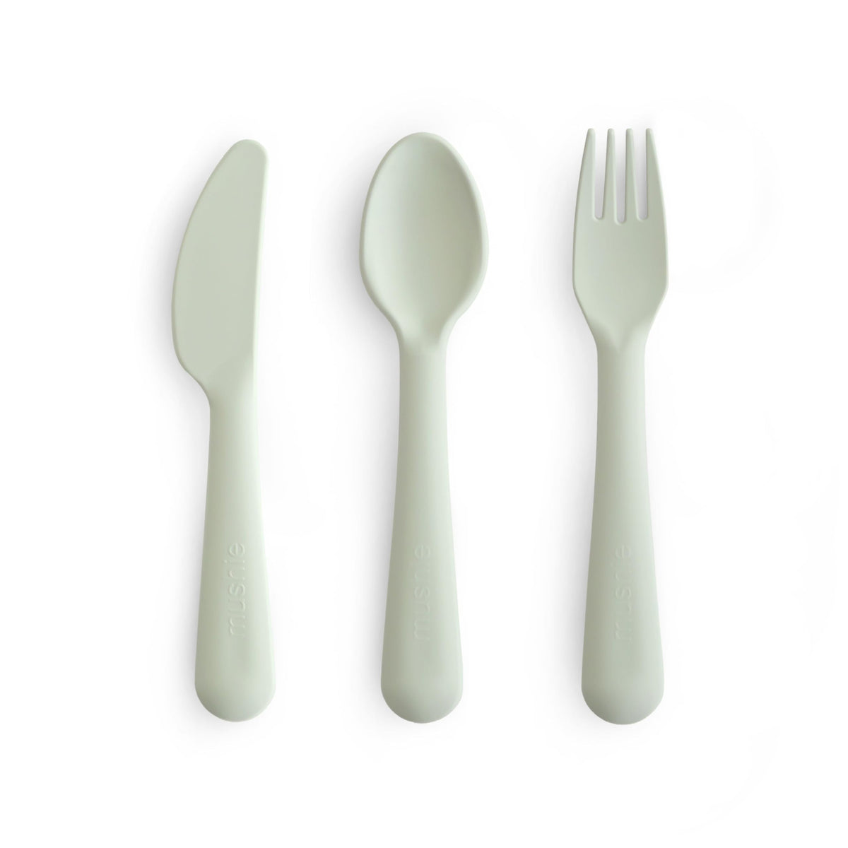 Mushie dinnerware cutlery set sage fork in hand supports easy self-feeding.
