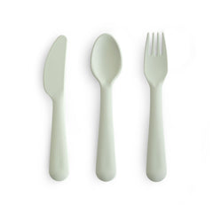 Mushie dinnerware cutlery set sage fork in hand supports easy self-feeding.