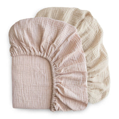 Mushie elastic fitted crib sheet with deep pockets for snug fit.