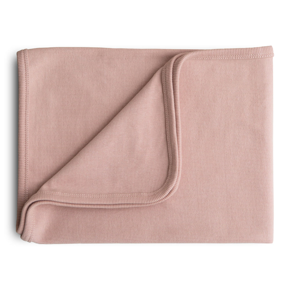 Mushie extra soft baby blanket folded in blush for cozy snuggles