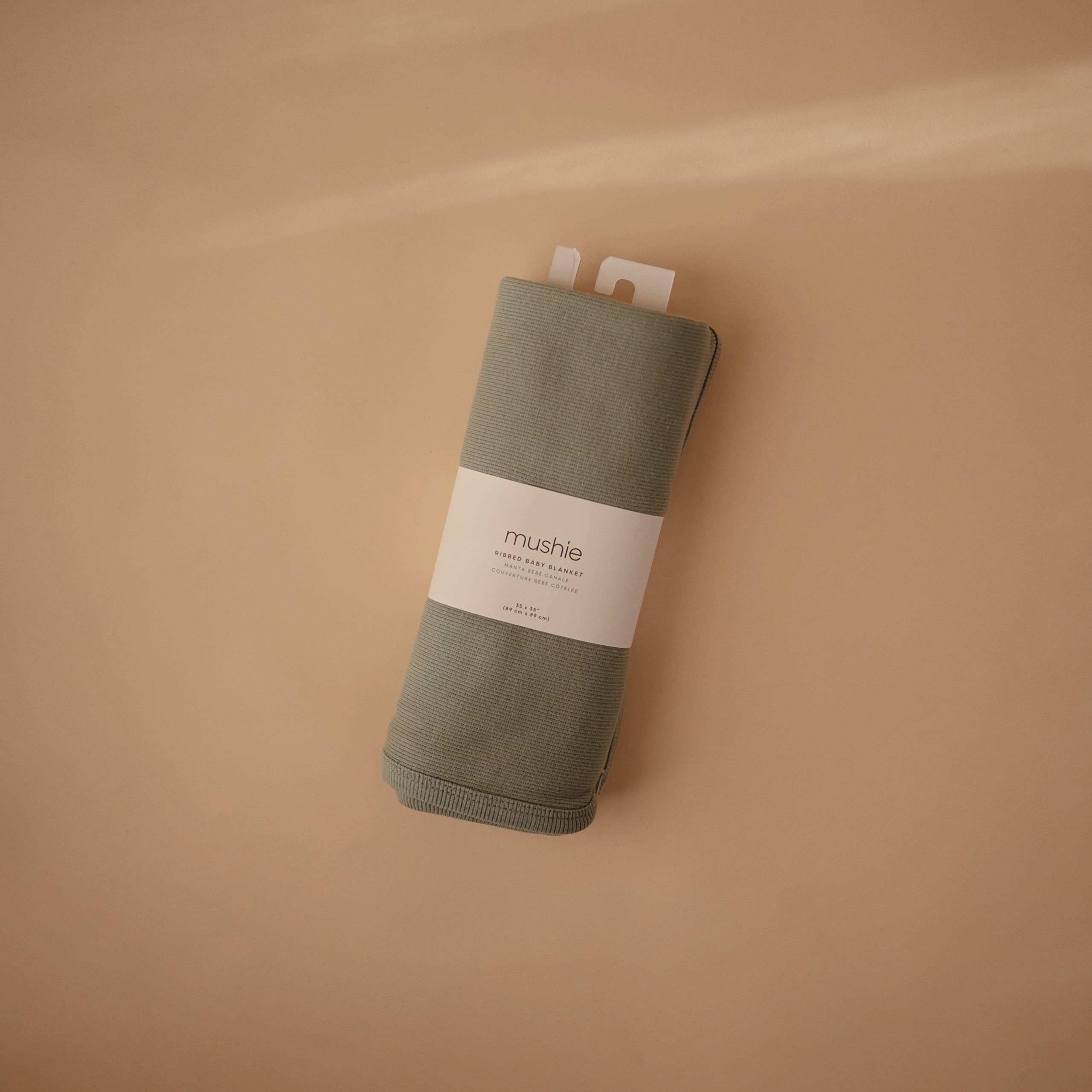 Mushie Roman Green ribbed blanket on stroller for on-the-go warmth