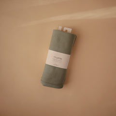 Mushie Roman Green ribbed blanket on stroller for on-the-go warmth