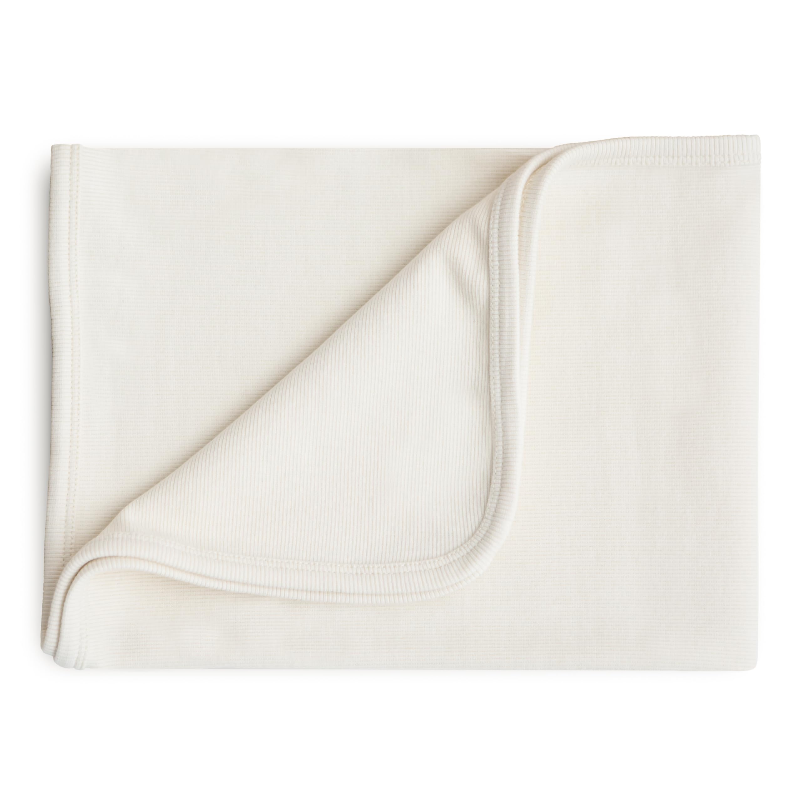 Mushie extra-soft blanket Ivory ribbed closeup for gentle skin contact and cozy warmth.