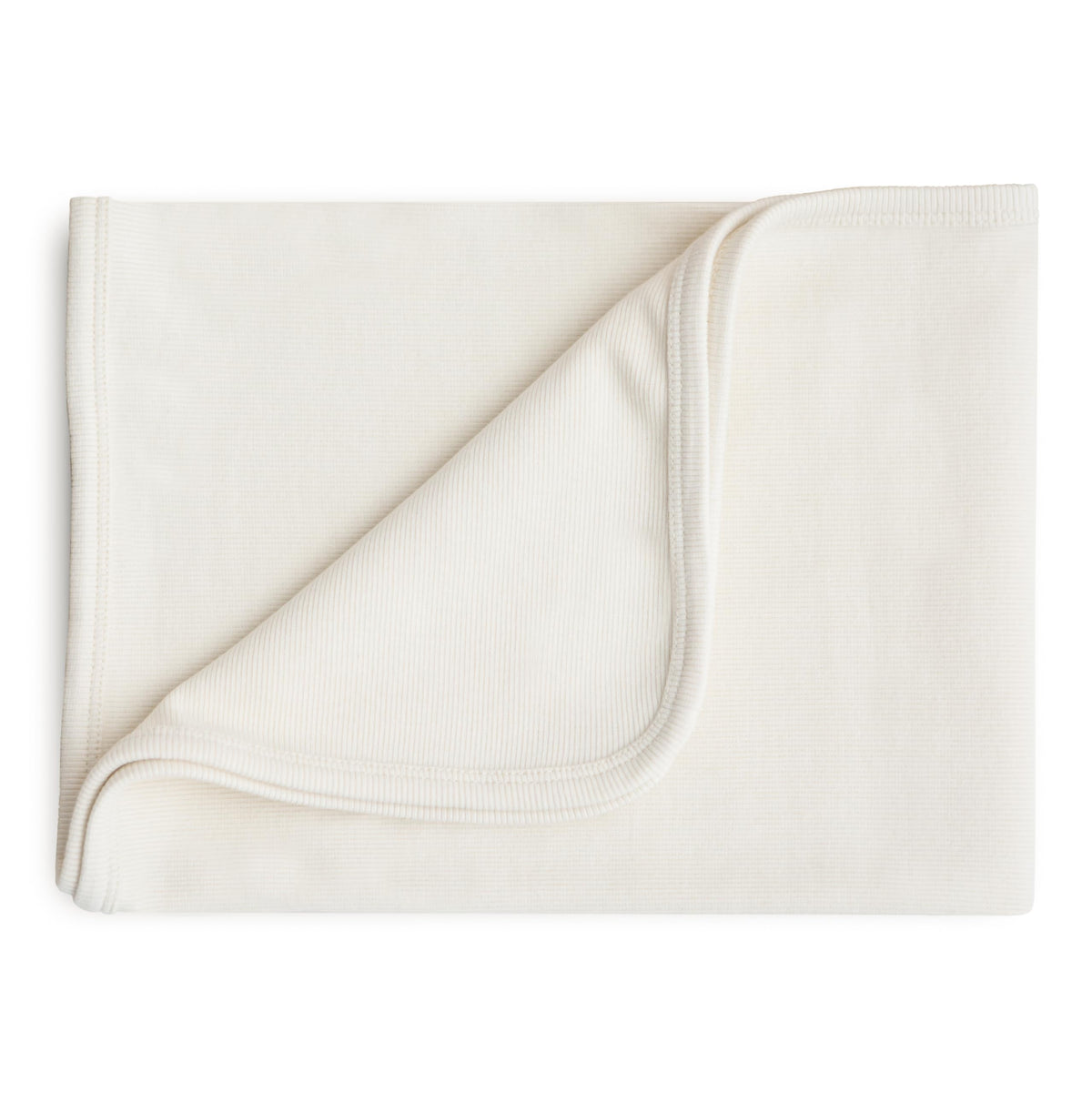 Mushie extra-soft blanket Ivory ribbed closeup for gentle skin contact and cozy warmth.