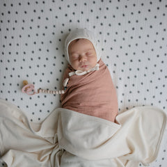 Mushie blanket Ivory ribbed in stroller use for on-the-go warmth and soothing calm.