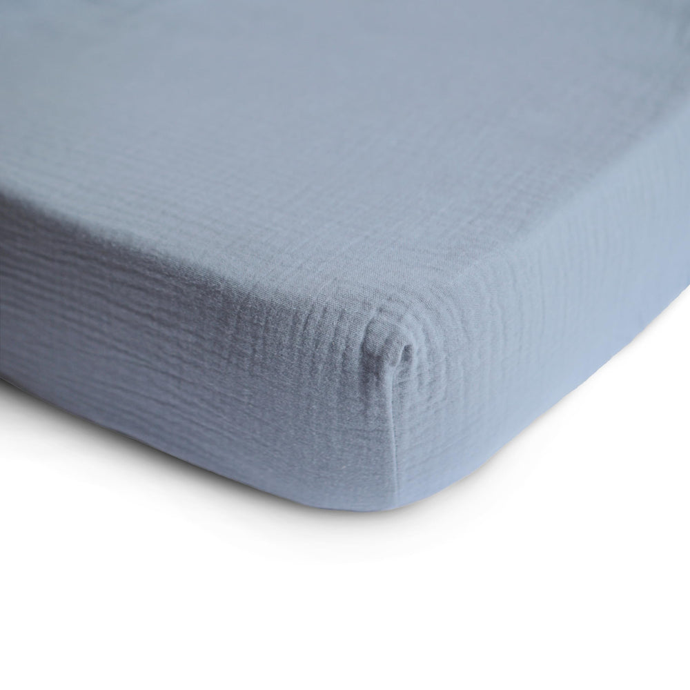 Mushie fitted crib sheet on a mattress shows a snug, secure sleep space.