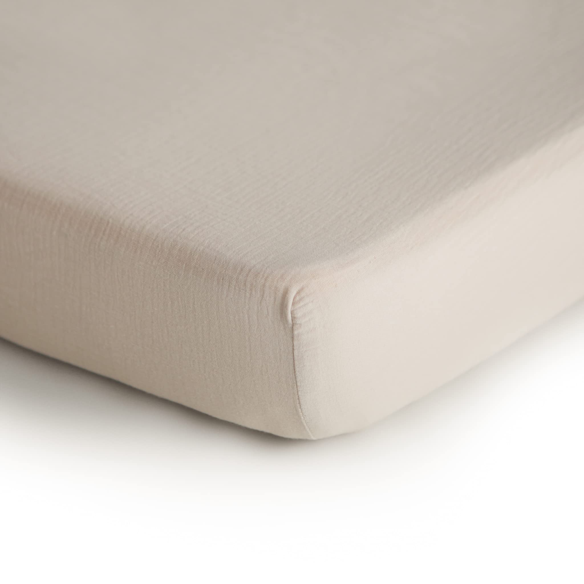Mushie muslin crib sheet fog on mattress shows a snug, breathable sleep surface.