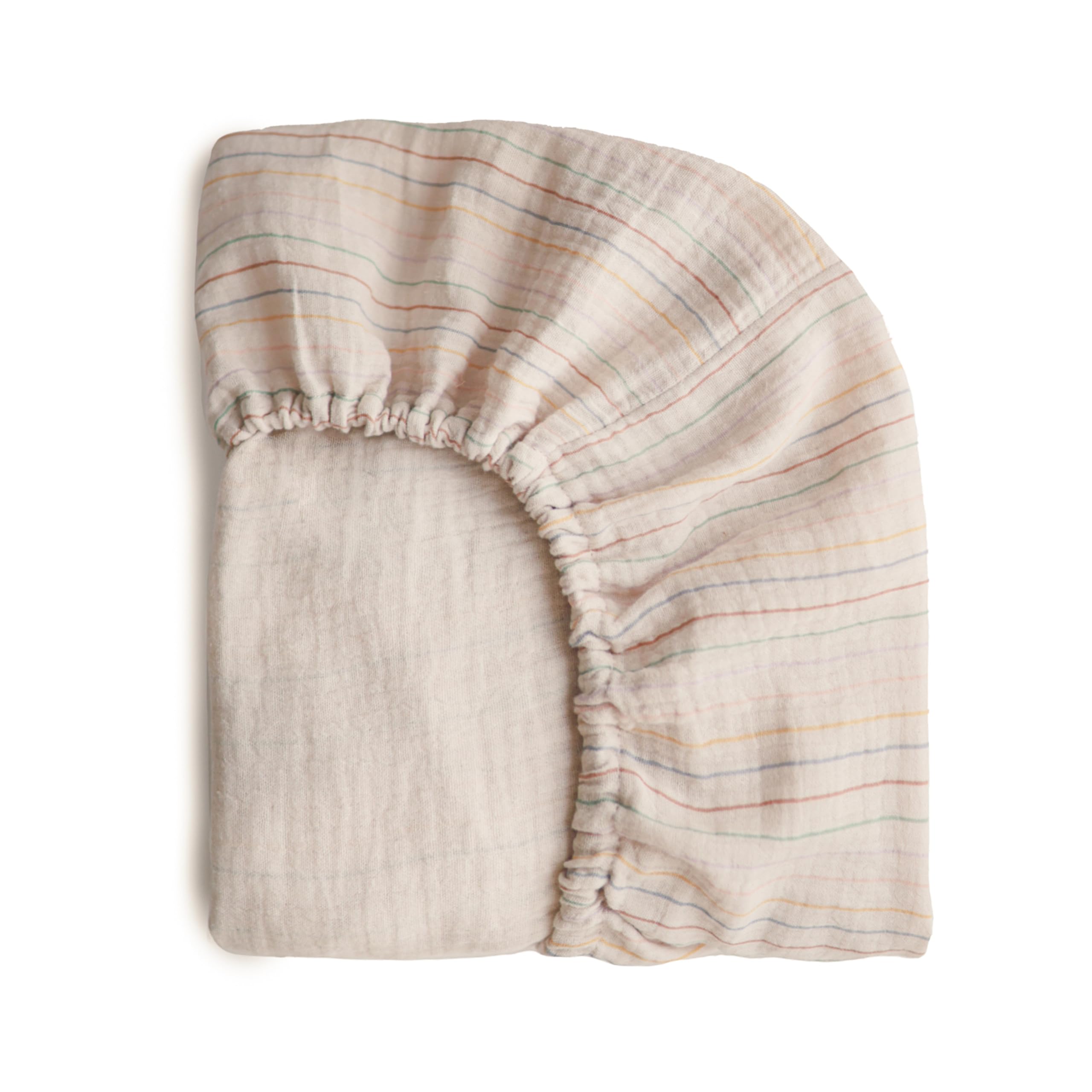 Mushie extra-soft muslin crib sheet in retro stripes on mattress for cozy sleep
