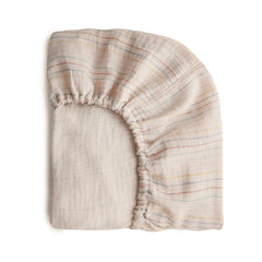 Mushie extra-soft muslin crib sheet in retro stripes on mattress for cozy sleep
