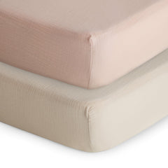 Mushie extra-soft muslin fitted crib sheet two-pack in blush and fog.