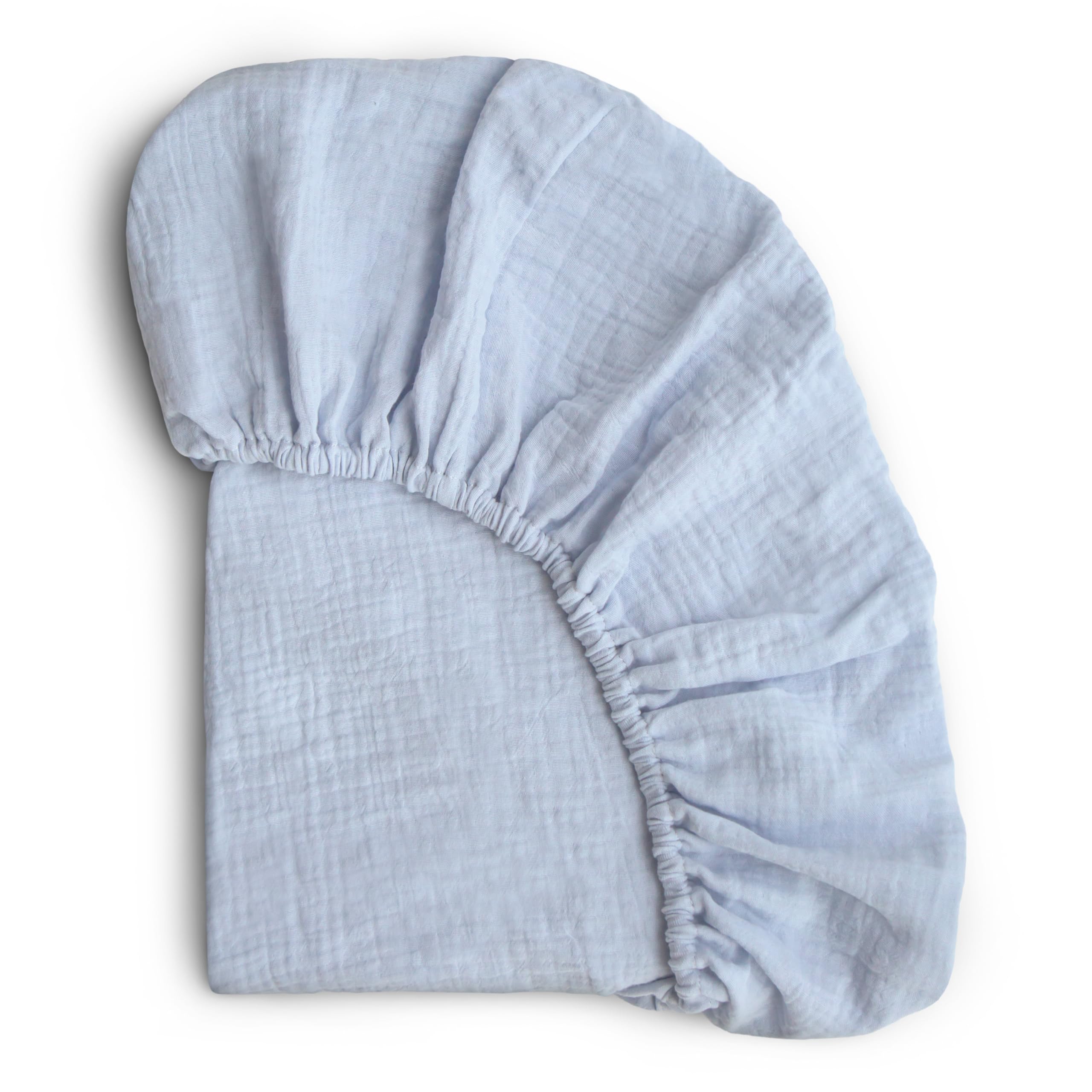 Mushie extra-soft muslin crib sheet baby blue closeup highlighting plush texture for gentle sleep.