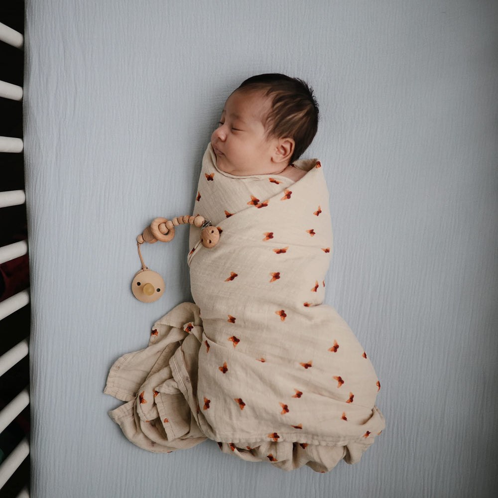 Mushie baby-blue muslin crib sheet prewashed for softness against skin.