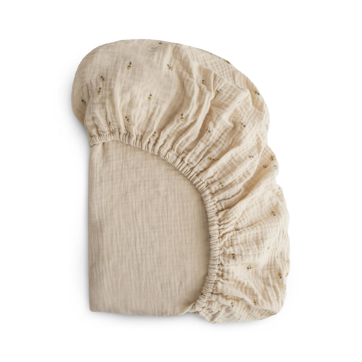 Mushie extra-soft muslin fitted crib sheet with bees pattern offers breathable warmth.