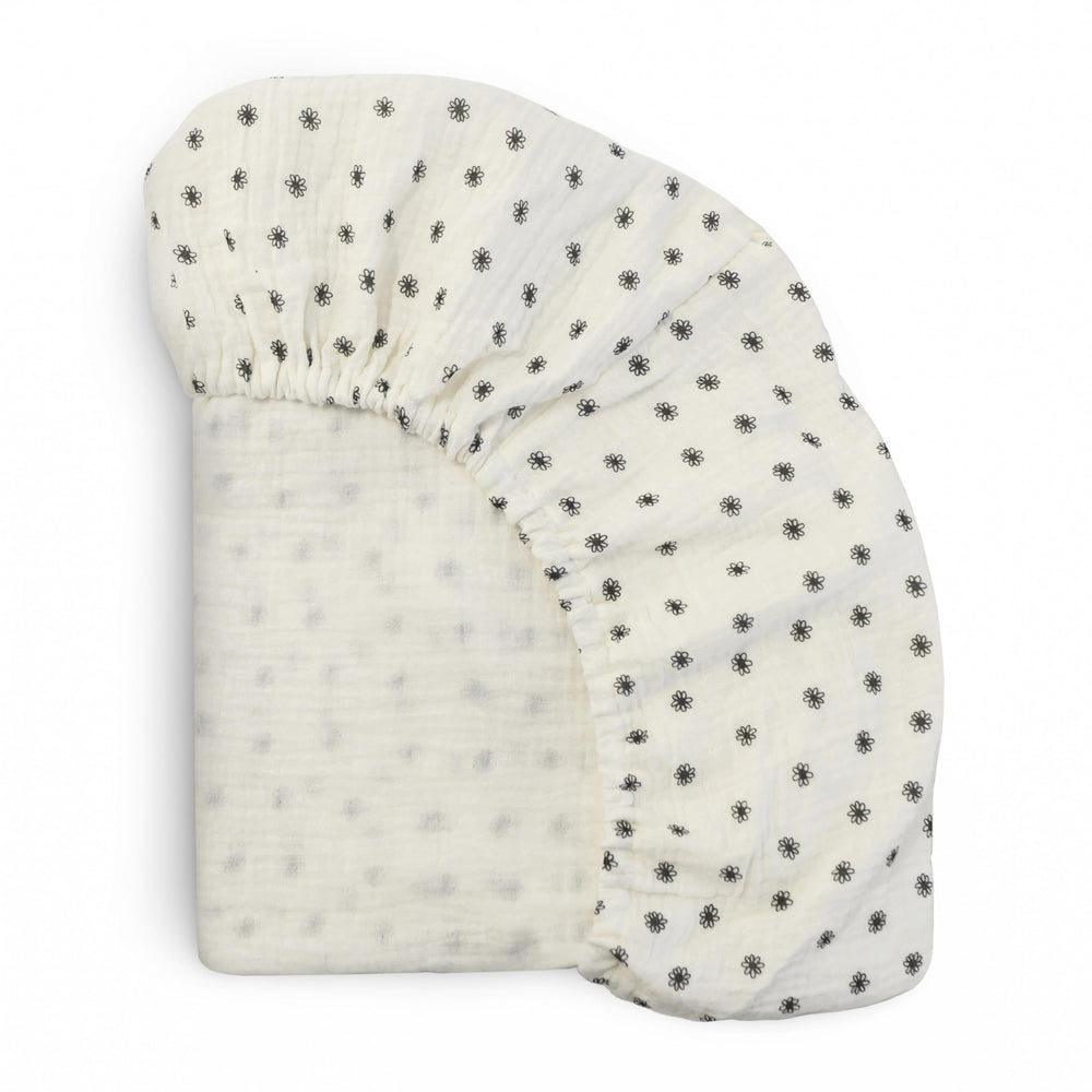 Mushie Extra-Soft Muslin Fitted Crib Sheet flatlay shows breathable cotton softness.