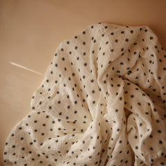 Mushie muslin sheet folded for easy storage and quick changing setups.